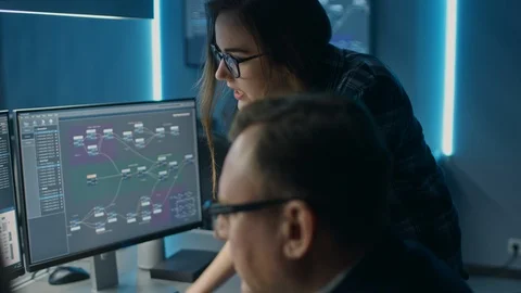 Male and Female IT Engineers / Programmers Having Discussion about Code Shown Stock Footage