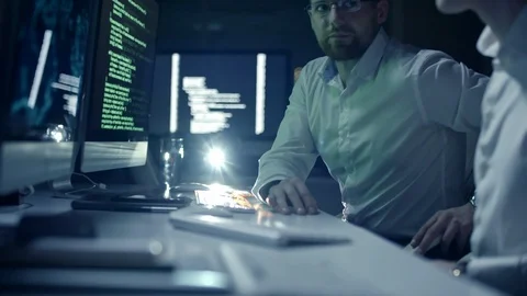 Male and Female IT Programmers Working Together in Dark Office Stock Footage 85827034