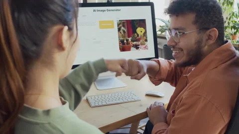Male and Female Programmers Bumping Fists After Testing New Feature on Computer Video stock 293169644
