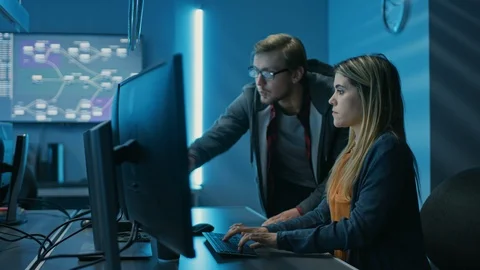 Male and Female Programmers Talking about Work, Solving Problems Together Stock-Footage 103273698
