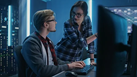 Male and Female Programmers Talking, Solving Problem, Using Computers Stock Footage 103274690