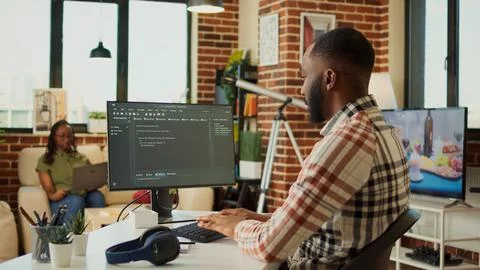 Male app developer using html script code on computer Stock Photos