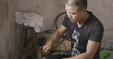 Male Apprentice working with Hammer on studio Stock Footage 141366683