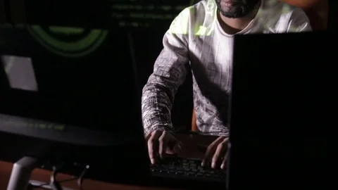 Male arabic hacker hacks computer in dark. Computer code reflecting on his face 스톡 동영상 71583368