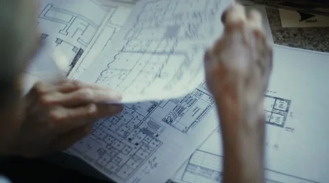 Male architect checking blueprints house construction planning Stock Footage