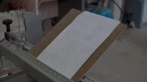 Male architect checking numbers on blueprint during house construction planing Stock Footage 89547264