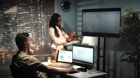 Male architect working in 3D software speaking with project enginner about Stock Footage 113046489