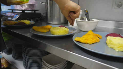 Male arm adding mixture of peppers and salt on plate to mashed potatoes. Chef Video stock 146615675