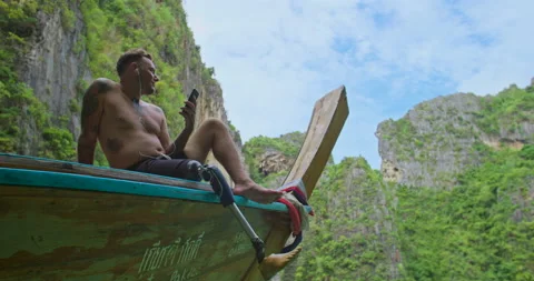 Male with artificial bionic leg sitting on boat front enjoy beautiful seascape. Video stock 201367174