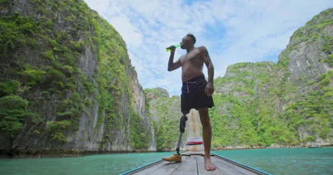 Male with artificial bionic leg standing on boat front seeing beautiful seascape Stock Footage 242445302