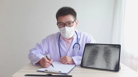 Male asian doctor working in the office hospital. discussing x-ray Stock Footage
