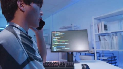 Male Asian IT freelancer programmer coding application software in room. Stock Footage 321036228