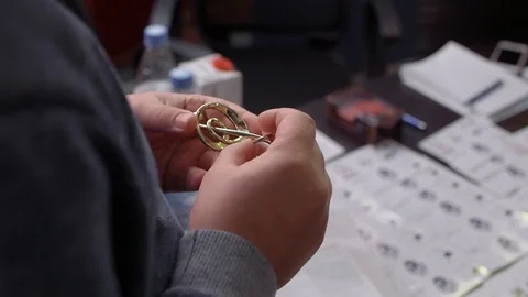 Male assembles a puzzle or mind-breaker, intelligence and thinking test Stock Footage 102436796