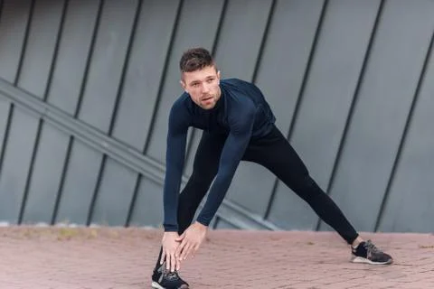 Male athlete doing warm up exercises. Sport, workout, healthy lifestyle conce Stock Photos