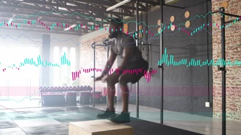 Male athlete launching from squat into explosive box jumps in gym data tracing Stock Footage 333936385
