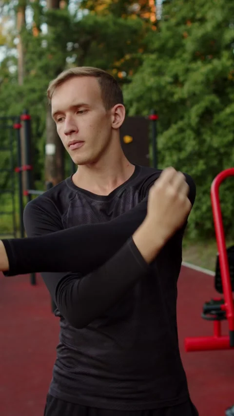 Male athlete performing a dynamic upper body warm up routine before a worko.. Stock Footage 341457475