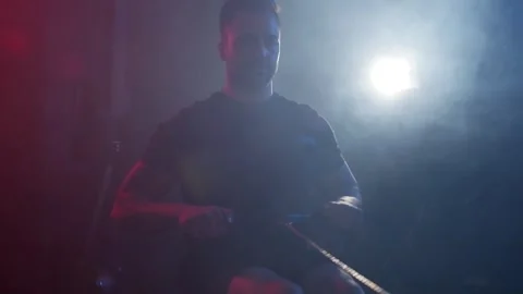 A male athlete pulls the oars on a rowing machine Stock Footage 262544086