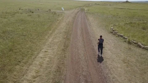 Male athlete running through the fields. Trail running athlete moving through Stock Footage 80845223