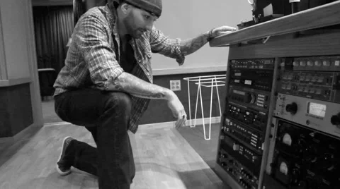 Male Audio Engineer adjusting Commercial Outboard Gear (Black &amp; White) Video stock 54671953
