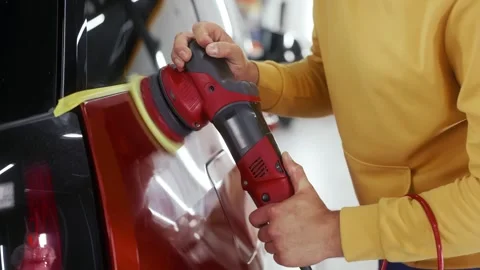 Male auto master providing professional detailing service in car studio Stock Footage 292432373