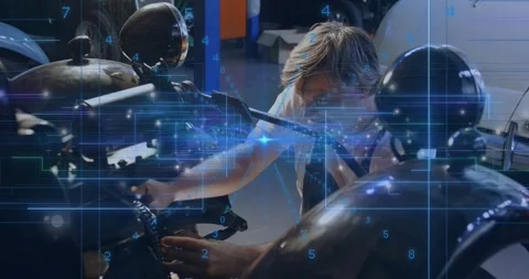 Male auto tech leaning over bike in garage, inspecting engine and turning knob Stock Footage 331227120
