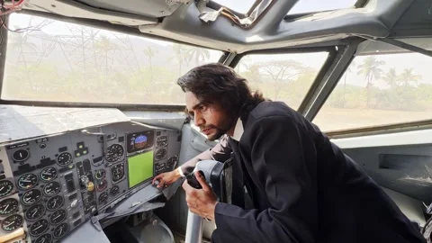 Male aviation learner observes screens showing engine data Stock Footage 308617040