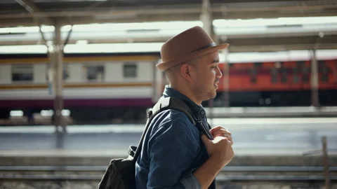 Male Backpacker arrival at platform railway. Freedom traveler young asian man. Stock Footage 217434095