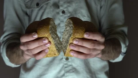 A male baker is breaking open rye buns. Close-up. Stock Footage 131515704