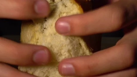 Male baker tears white bread into two parts. Close-up macro. Stock Footage 131517469