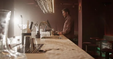 Male bar owner using computer at counter Stock Footage 239165817