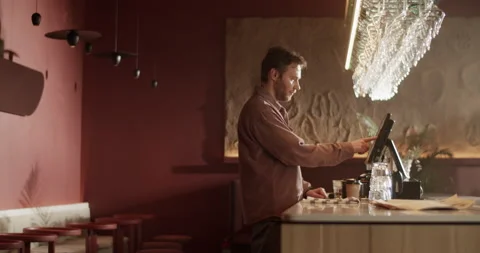 Male bar owner using computer at counter Video stock 239168572