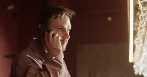 Male barkeeper talking on smartphone with client booking table Stock Footage 239169097