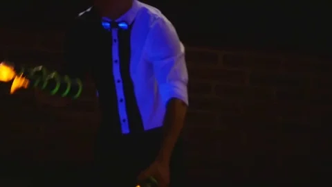 Male bartender juggling bottles mith fire. Barman show, clear shots, man Stock Footage