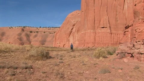 Male at base of Wingate Cliffs Gallup, New Mexico USA Stock Footage 103550792