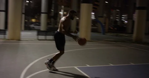 Male basketball player making a slam dunk at night Stock Footage 107637341