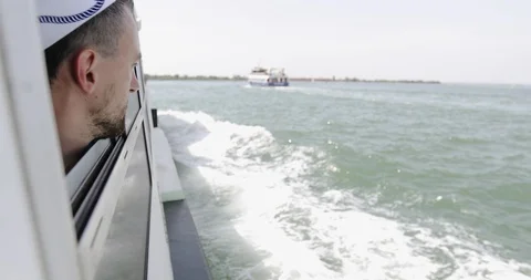 Male bearded face is looking through the window of the yacht. Stock Footage 118424366