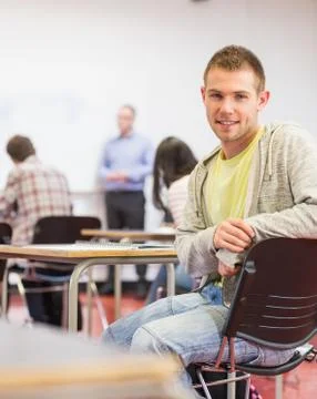 Male with blurred teachers students in classroom Stock Photos