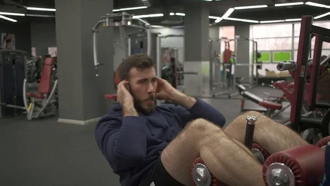 Male bodybuilder is training in the gym and performs a control for abdominal. Stock Footage 128997341