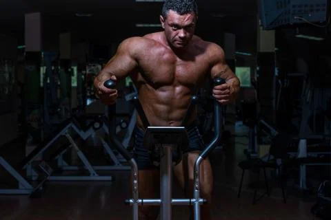 Male bodybuilder using the elliptical machine Stock Photos