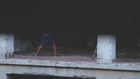 Male boxer doing shadow boxing exercise in an old abandoned factory Stock Footage 79846566