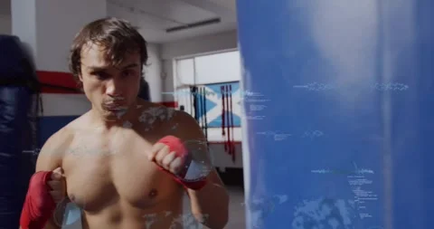 Male boxer exhaling while punching bag with red wraps, camera revealing form, Stock Footage 330577060