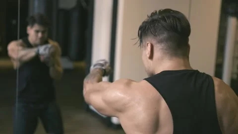 Male boxer shadowboxing in front of mirror Stock Footage 89854589