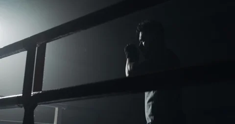 Male boxer training in the dark ring. Slow motion. Silhouette. Boxing concept. Stock Footage 108654974