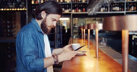 Male Browsing Smartphone in Cafe 動画素材 116319745