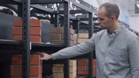 Male Builder Choosing Bricks In Hardware Store Stock-Footage 121832927