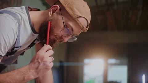 Male builder drawing construction plan on the large format paper Video stock 170501682