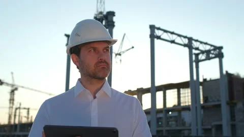 Male builder engineer man worker builder architect in hard hat with tablet Stock Footage 157665795