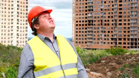 Male builder foreman, worker or architect on construction building site looks Stock Footage 111865292