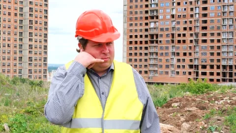 Male builder foreman, worker or architect on construction building site showing Stock Footage 111867630