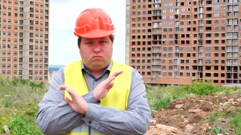 Male builder foreman, worker or architect on construction building site showing Stock Footage 111869638